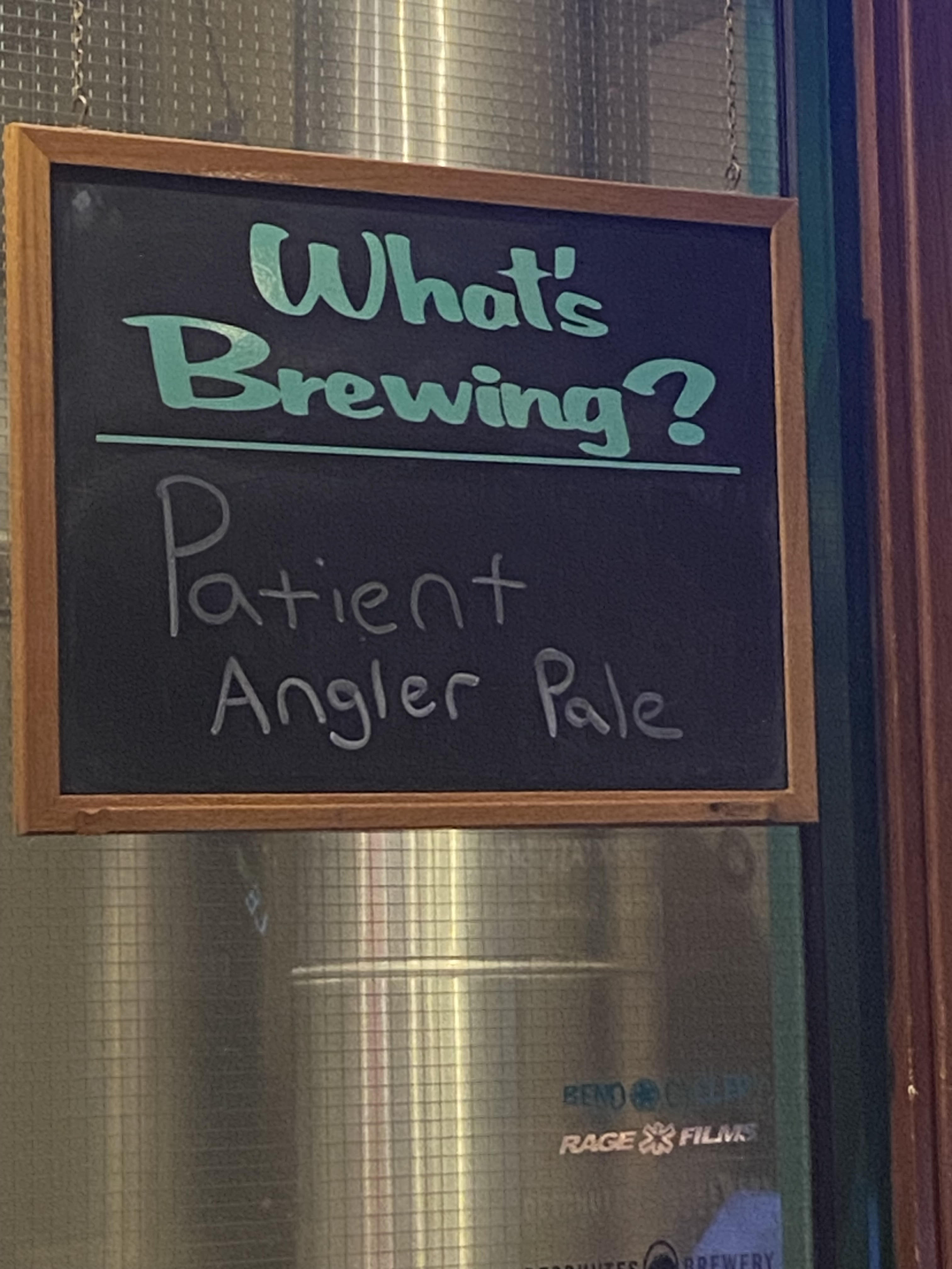 A "What's Brewing?" chalkboard sign at Deschutes Brewery announcing Patient Angler Pale